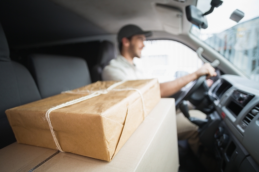 A delivery man inside a delivery van