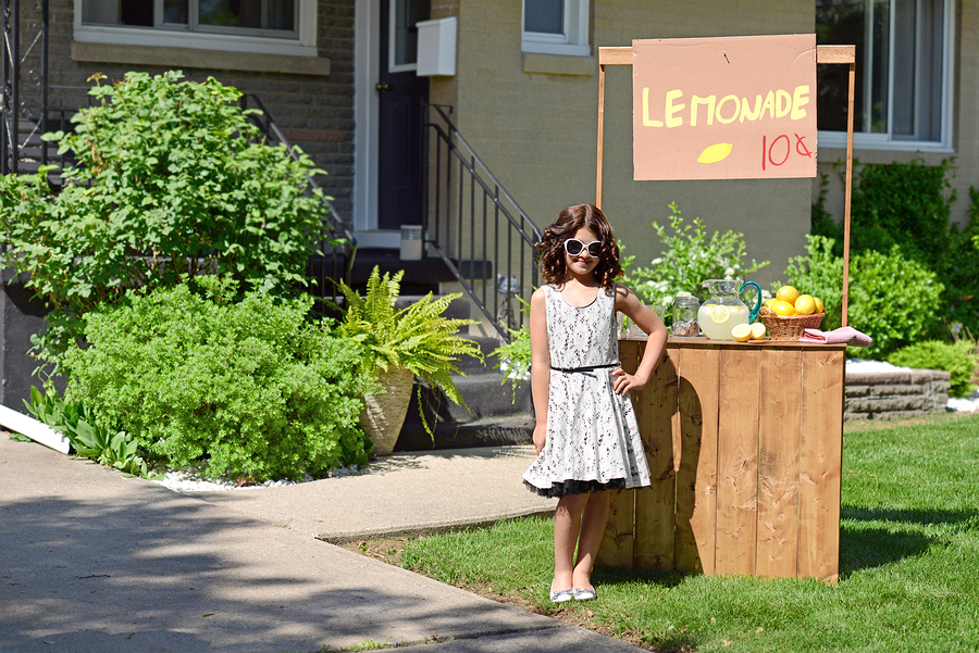 girl selling lemonade at home