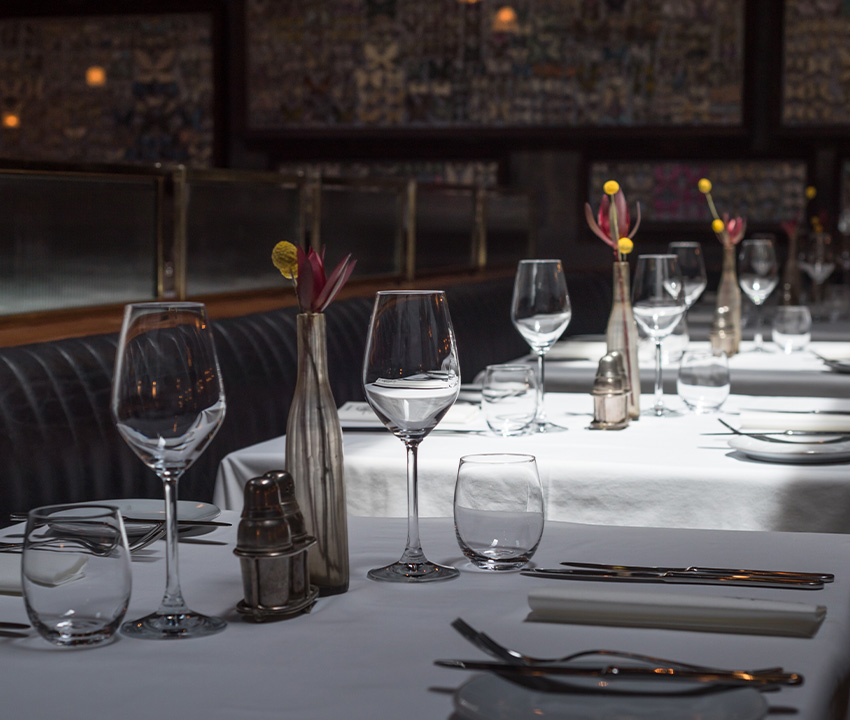 Interior of a modern restaurant with fine dining served for dinner