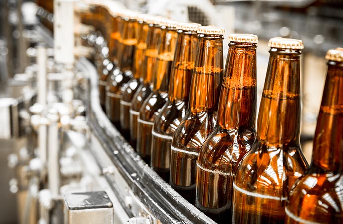 beer bottles on the conveyor belt distillery insurance