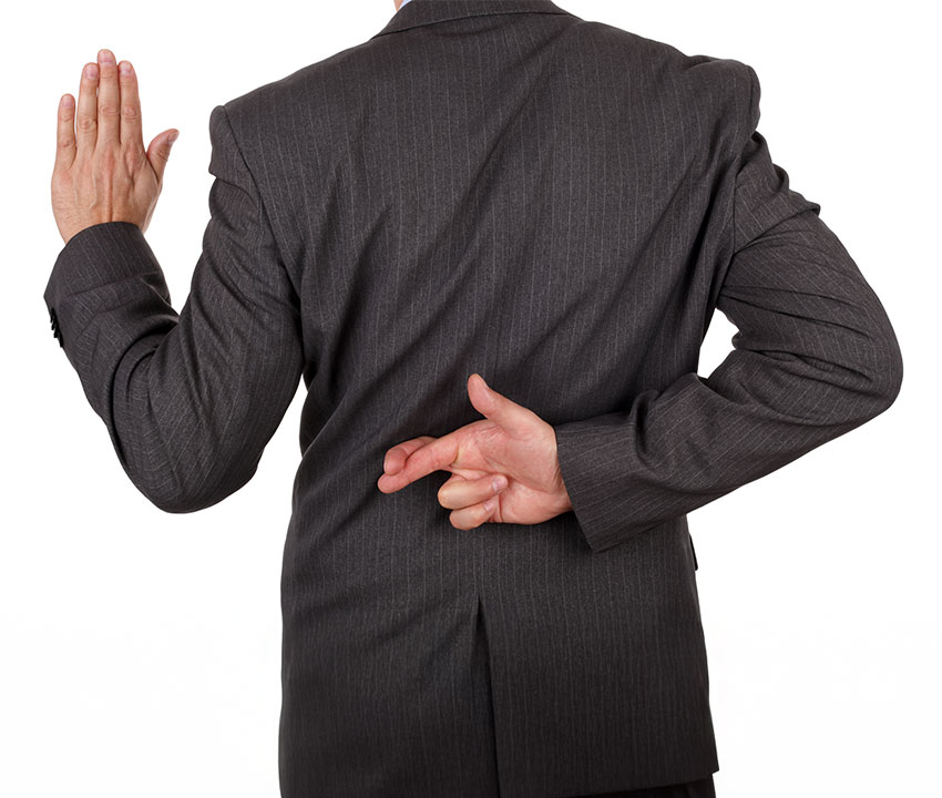 A man in a suit raising his hand to take an oath with his fingers crossed behind his back, representing misrepresentation by an insurance agent.