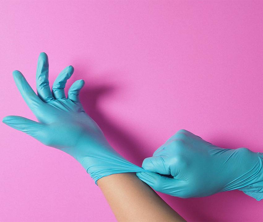 Putting on Disposable Nitrile Gloves for Protection