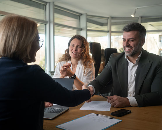 Client shaking hands with insurance agent in office