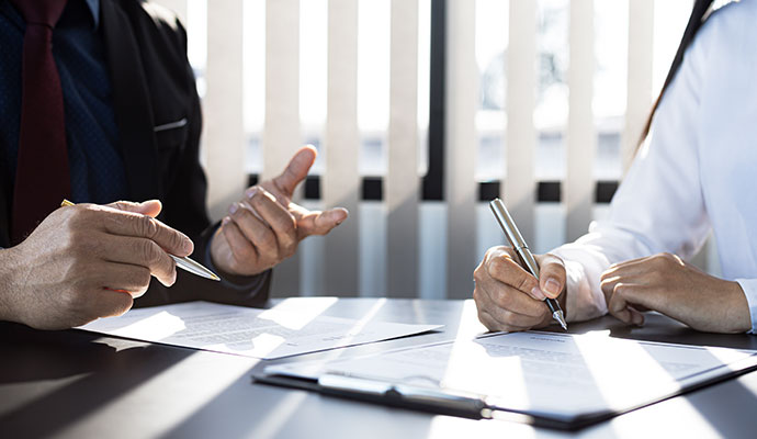 Client signing insurance documents with agent