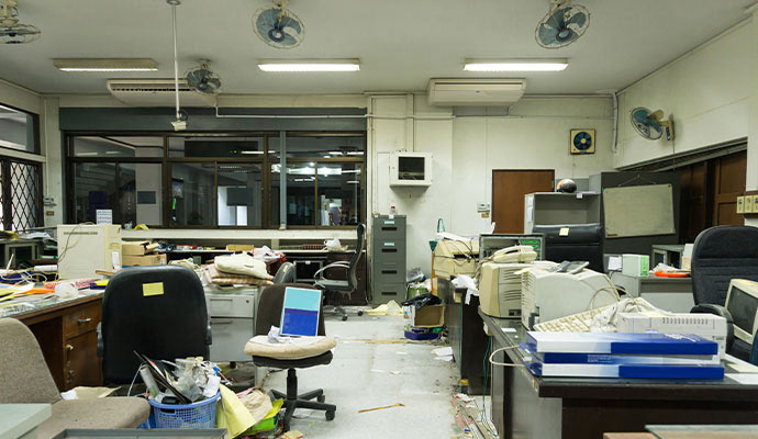 Cluttered office space computers and furniture