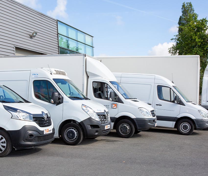 White truck van standing in front of the commercial building