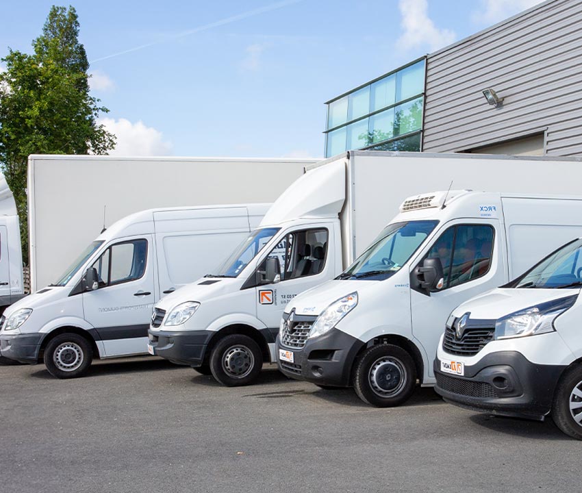 White truck van standing in front of the commercial building