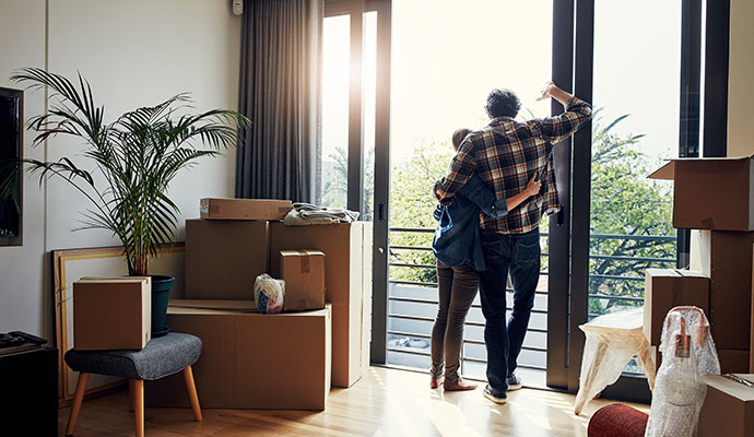 Couple looking out the window of a new home