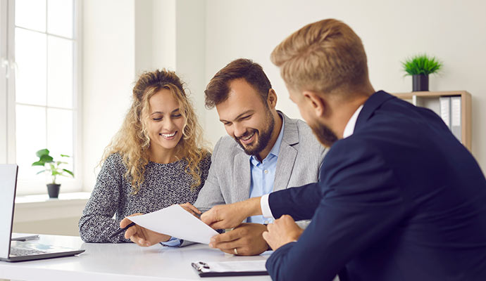 Couple reviewing insurance documents with agent