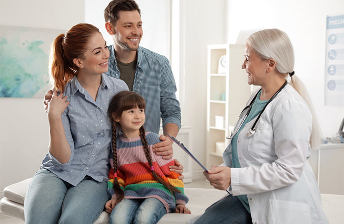 family with child visiting doctor in hospital