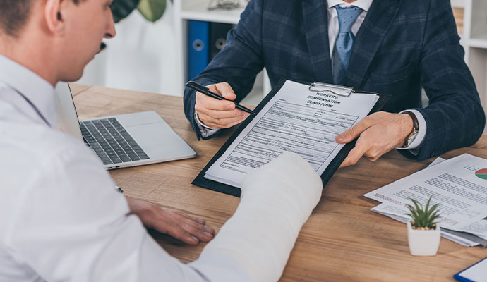 Injured employee filing insurance claim form