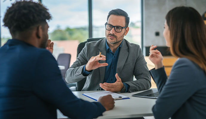 Insurance advisor explaining business insurance options to clients