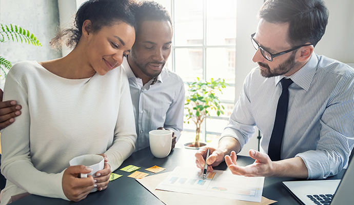 Insurance agent consulting with young couple