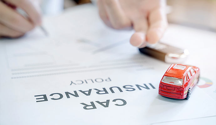 Person signing a auto insurance policy document
