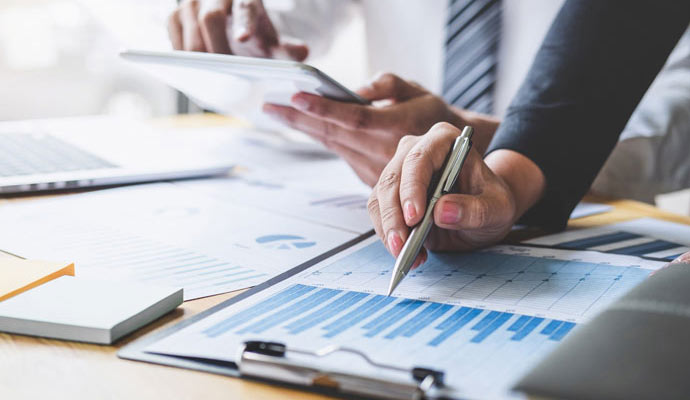 Professionals analyzing financial charts and reports