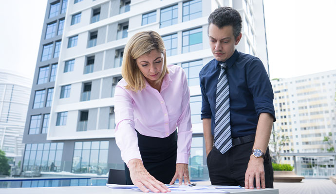 Reviewing property documents in front of office building