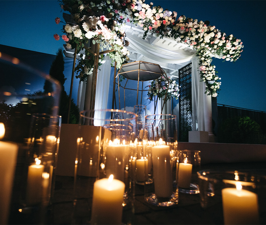 special event flower garland hangs before blue wall in the garden