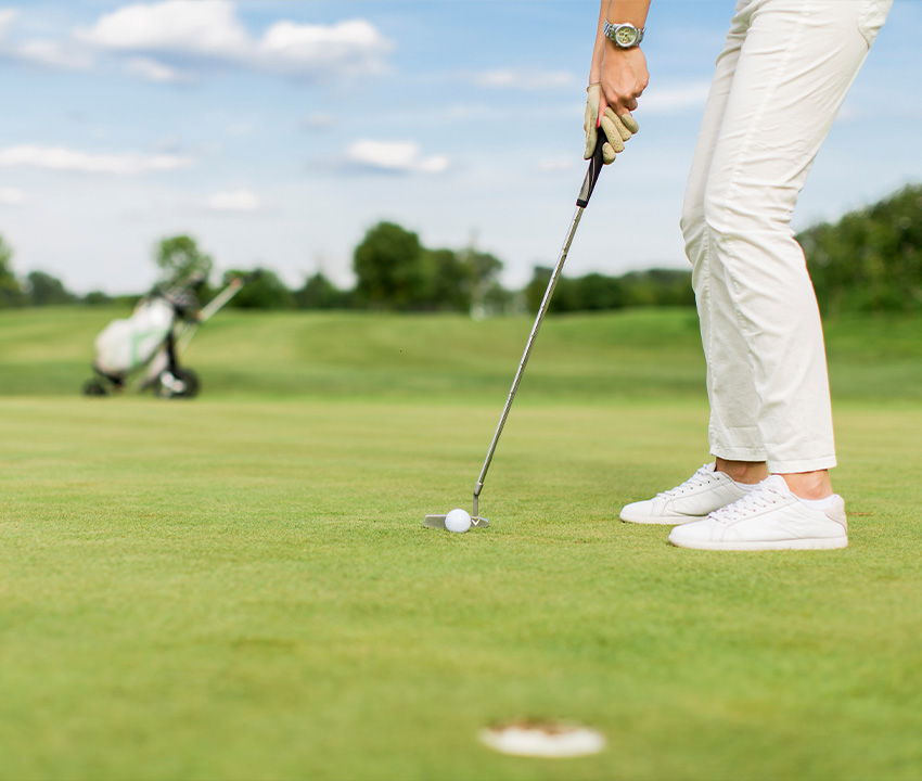 young woman playing golf courses insurance